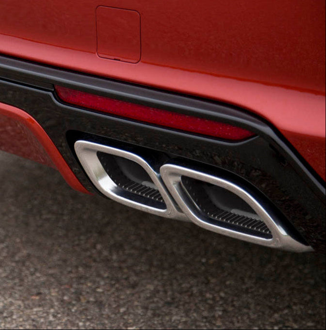 Close-up of a car's exhaust system with a red body and black trim.